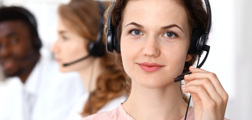 Call center operator.Young beautiful  brunette woman in headset. Business concept