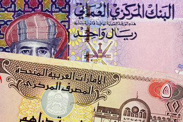 A close up image of an Omani one rial note with a United Arab Emirates five Dirham bill
