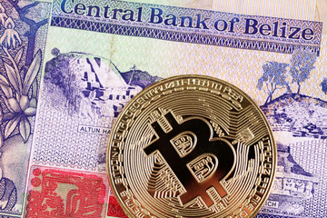 A macro image of a Belize two dollar bill with a golden bitcoin close up