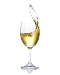 White wine splashing out of glass isolated on white background.
