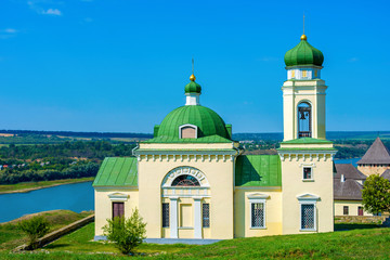 Photo of old green white church in Khotyn