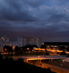 Fototapeta na wymiar A stormy sky over the evening city