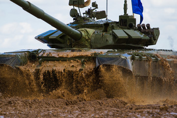 Army tank crosses the water obstacle
