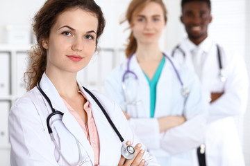 Happy doctor woman  with medical staff at the hospital