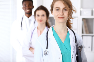 Fototapeta premium Happy doctor woman with medical staff at the hospital