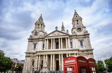 Foto op Plexiglas red phone boxes and red bus passing Saint Paul's Cathedral in London at cloudy day © offcaania