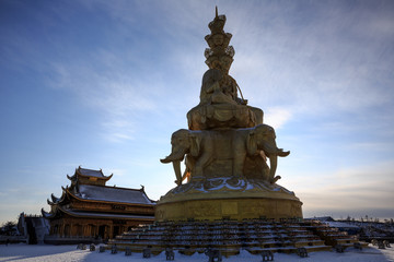 Fototapeta na wymiar Emeishan, Mount Emei, Sichuan Province China. Sacred Buddhist Mountain. Snow Covered Mountain, Golden Elephant Statue, Shrine. Winter scenery, ice and snow. Silhouette, golden summit temple, religion