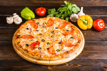 Italian pizza. Creative author's pizza with tomatoes, olives and fish