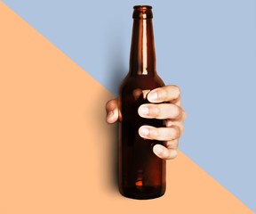 Hand holding beer bottle without label isolated on white