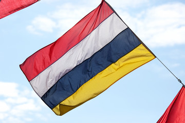 four-color flag on sky background