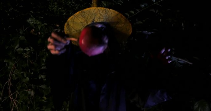 Wicked Witch show enchanted apple in Halloween Horror Scene