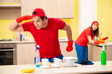 Cleaning professional contractors working at kitchen