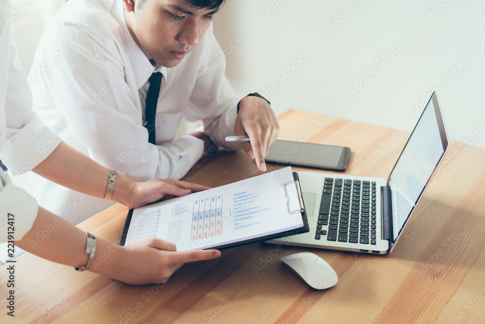 Aufkleber team working together. modern workplace desks and computers, documents graphs showing the results of