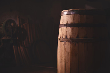 wooden barrel on a dark background, in a workshop, in an old room.