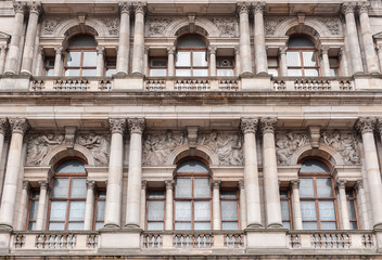 Fototapeta na wymiar Glasgow, Scotland, UK - June 17, 2012: Detail of facade of Brown stone Glasgow City Chambers building shows windows, balconies and frescoes.