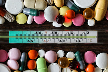 Medications on a textured wooden background