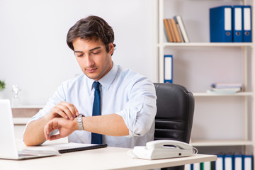 Young handsome businessman working in office