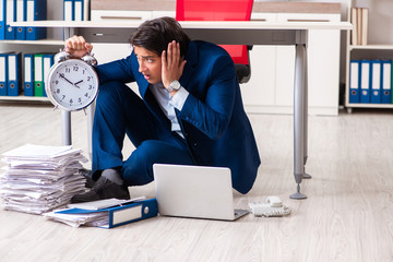 Tired exhausted businessman working overtime in office