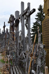 Famous Hill of Crosses in Lithuania.  Wooden crosses and crucifixes at the Hill of Crosses in Siauliai. Shallow DOF