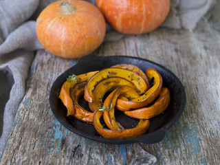 Fried baked on grill pumpkin with spices, olive oil, herbs