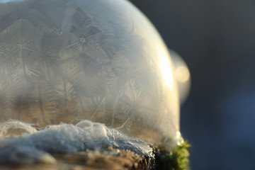 Soap bubbles freeze in the cold. Winter soapy water freezes in t