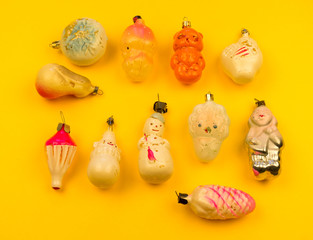 Old fur-tree toys on a yellow background