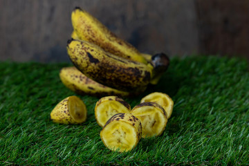 Sweet golden banana fruit isolate on Green grass
