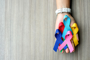 World cancer day (February 4). colorful awareness ribbons; blue, red, green, pink and yellow color...