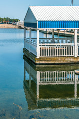 Fototapeta na wymiar Empty pier, dock, harbor marina, covered sheltered picnic area