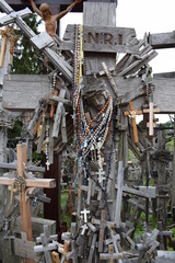 Famous Hill of Crosses in Lithuania.  Wooden crosses and crucifixes at the Hill of Crosses in Siauliai. Shallow DOF
