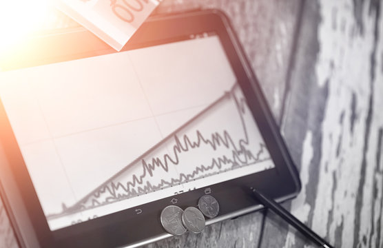 The graph of income growth. Electronic tablet with a graph of gr