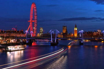 London Cityscape at Twilight include Famous Landmark; Big Ben, Jubilee Bridge, and London Eye with Light Trails of Boat in Thames River View from Waterloo Bridge