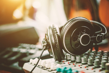 Fototapeta na wymiar Stereo headphones with the mixer on the Desk in the Studio
