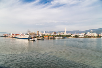 Fototapeta premium Sunrise cityscape view of Penang Island from Straits of Malacca