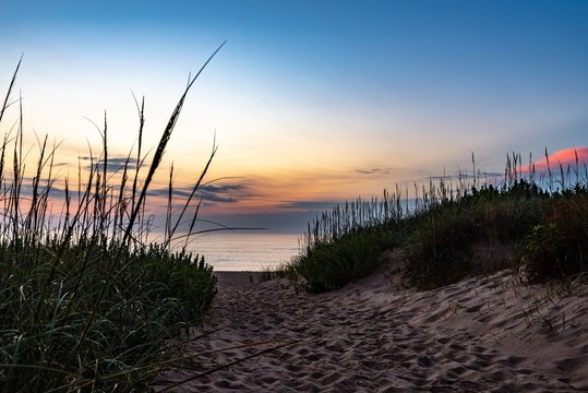 Sunrise on the beach at Kill Devil Hills North Carolina in the Outer Banks. Sea Oats in the foreground