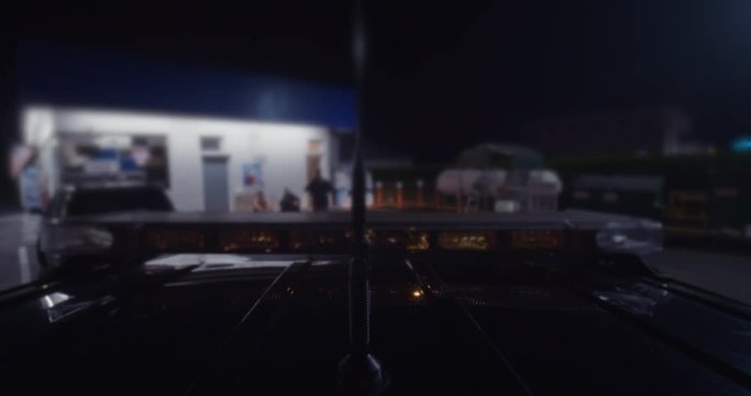 top view of police car officer with suspects near a gas station