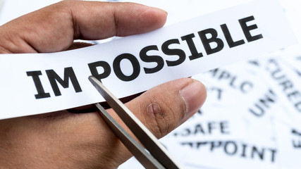 impossible text or word meaning on paper in hand holding