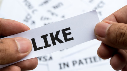 like text or word meaning on paper in hand holding