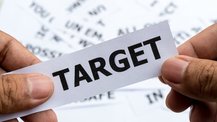 target text or word meaning on paper in hand holding