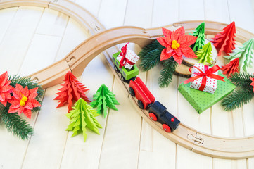 toy wooden train carries a box with gift the child