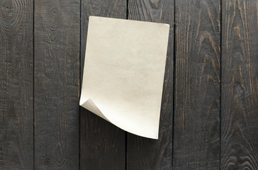 old paper on dark wooden wall