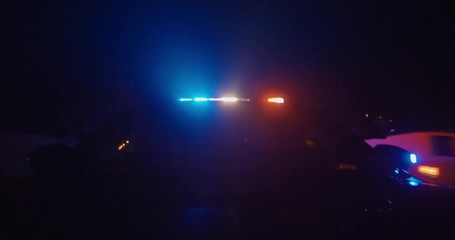 front view of police car from hood with lights on in pursuit