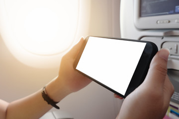 touching and slide mobile phone screen on airplane or aircraft,blank mobile phone screen mock up,selective focus