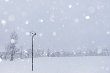 Scenery with a park clock in a snowy day, Tokyo, Japan.