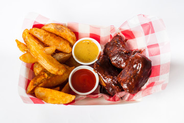 buffalo wings and french fries basket on white background