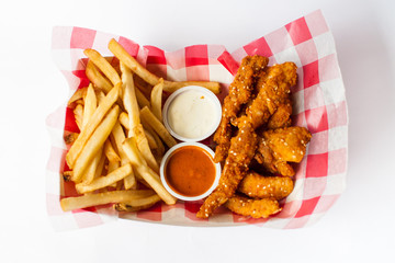 chicken sticks and french fries basket on white background