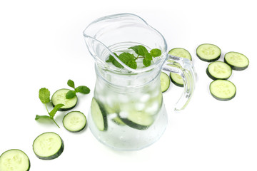 Cucumber and mint lemonade in a jar on a white background with copyspace