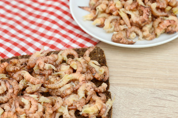 north sea crabs on black bread on table