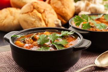 Stew soup with meat, potatoes, mushrooms and red pepper