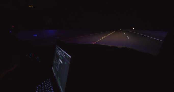 police car in pursuit lights flashing inside of car view with computer